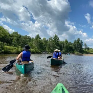 Students canoe trip in river